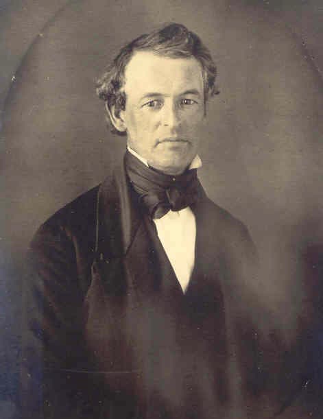A formal portrait of a 19th-century man with wavy hair and a bow tie.