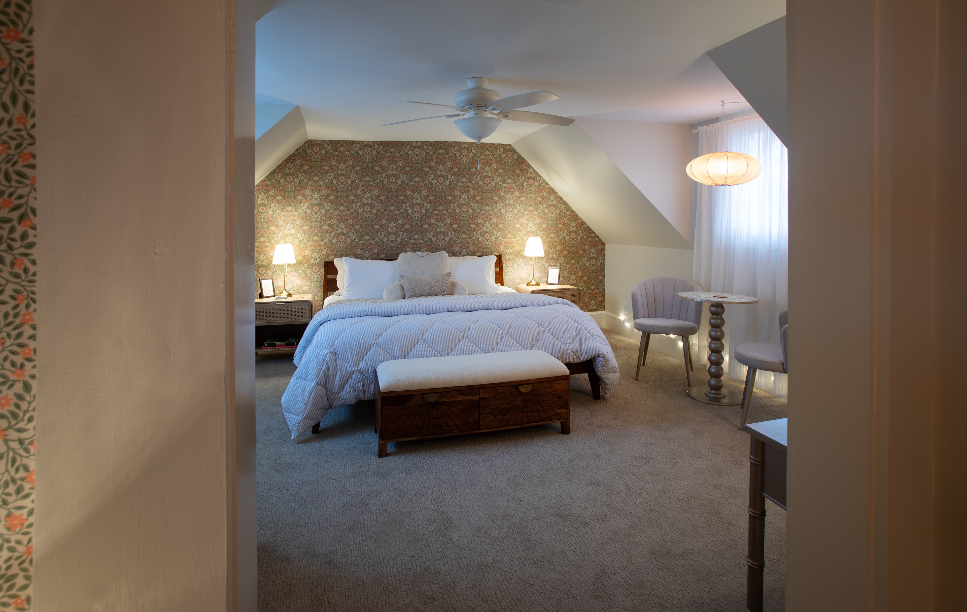 A cozy bedroom with a neatly made bed, soft lighting, and stylish decor.