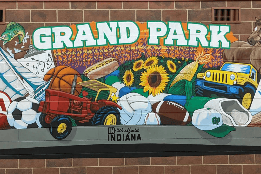 A colorful mural featuring sports equipment, agricultural elements, and the text "GRAND PARK" in Westfield, Indiana.