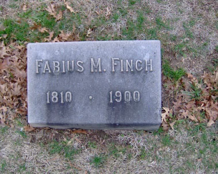 Gravestone of Fabius M. Finch, 1810-1900, on a grassy area.