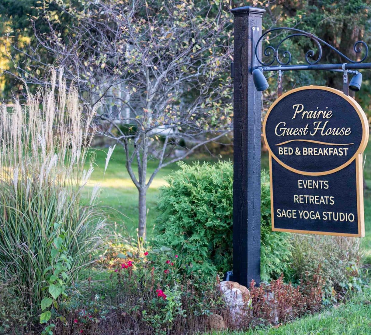 Sign for Prairie Guest House, a bed and breakfast offering events, retreats, and a yoga studio.