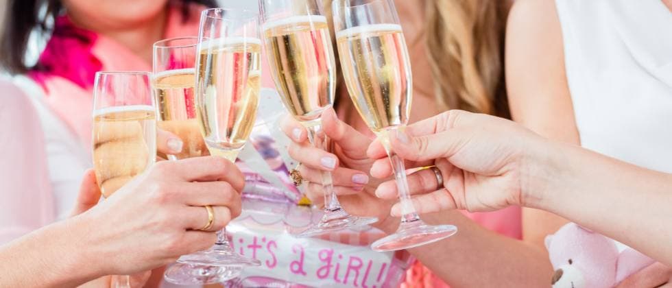 A group of women toasting with champagne glasses at a celebration. A group of women toasting with champagne glasses at a celebration.